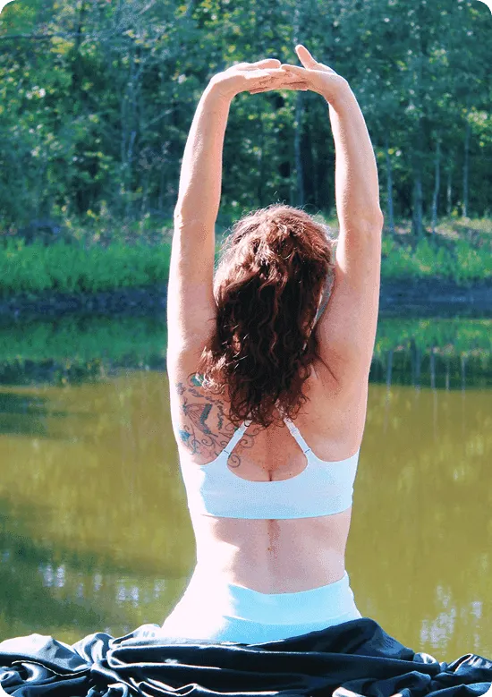 Woman stretching by peaceful lake